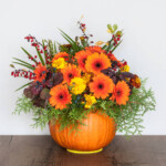 Autumn bouquet in a vase made out of pumpkin for Thanksgiving Day